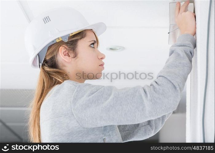 young woman doing diy with a helmet