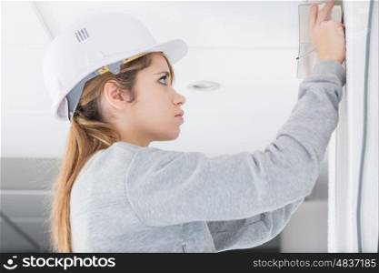 young woman doing diy with a helmet