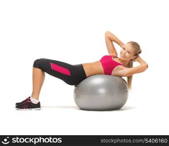 young woman doing exercise on fitness ball