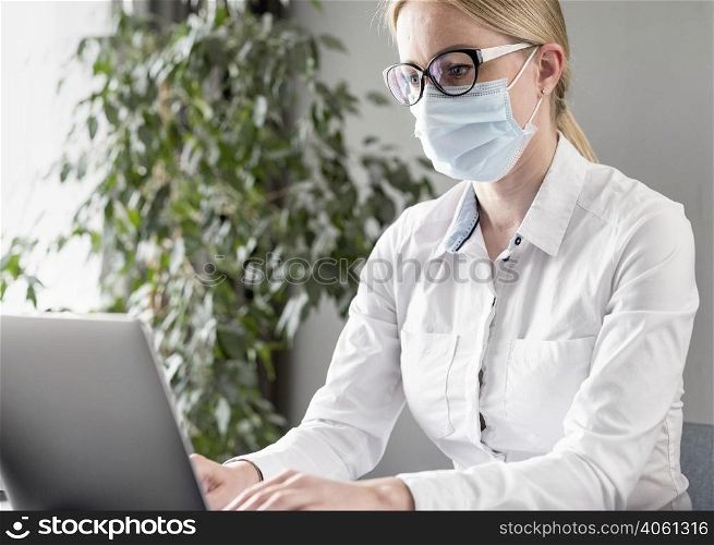 young woman doing her classes while wearing face mask