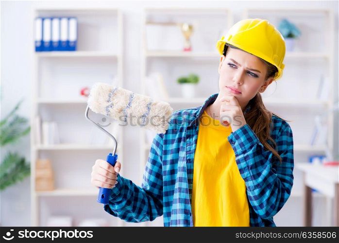 Young woman doing painting at home