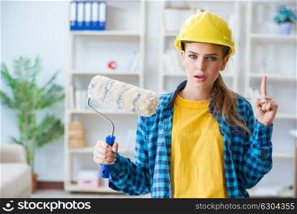 Young woman doing painting at home. The young woman doing painting at home