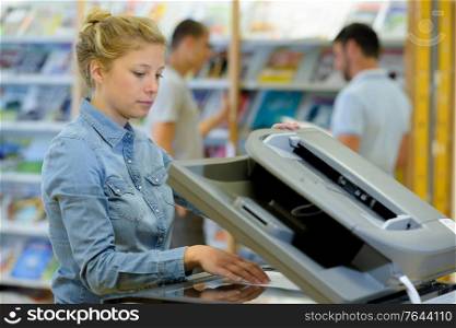 young woman doing photocopies in the office