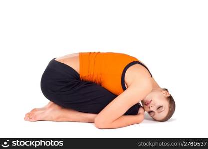 Young woman doing relaxing yoga exercise called embryo pose, sanskrit name: Pindasana, isolated over white background