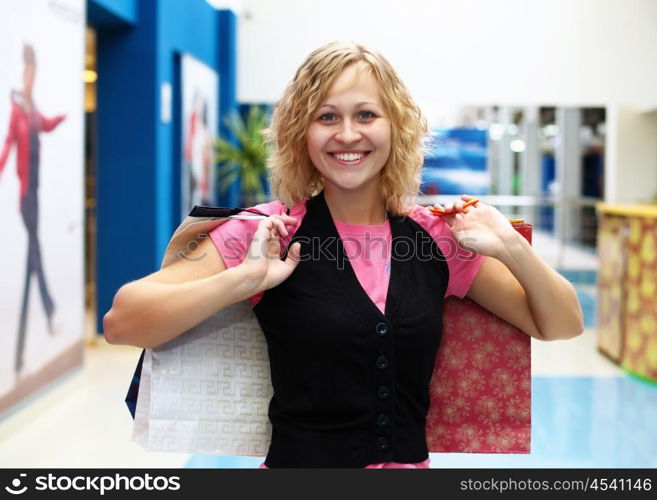 Young woman doing shopping and choosing clothes