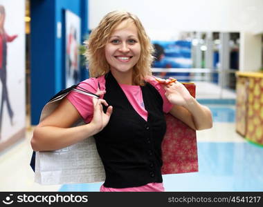 Young woman doing shopping and choosing clothes