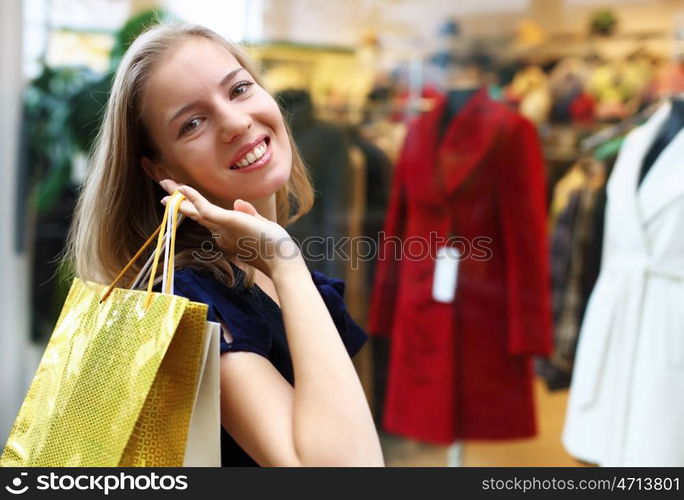 Young woman doing shopping and choosing clothes