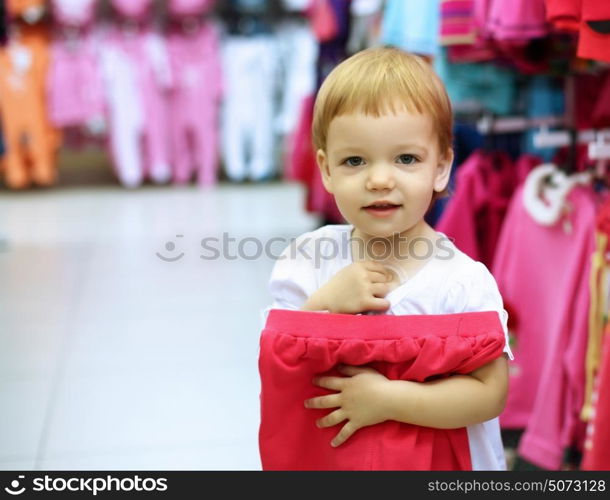 Young woman doing shopping and choosing clothes