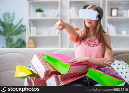 Young woman doing shopping with virtual reality glasses