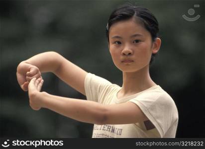 Young Woman Doing Tai Chi Pose