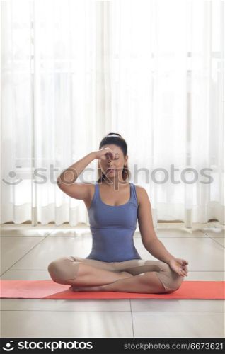 Young woman doing yoga and meditation