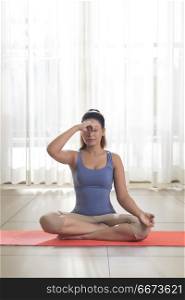 Young woman doing yoga and meditation