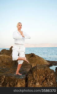 Young woman doing yoga exercise outdoors