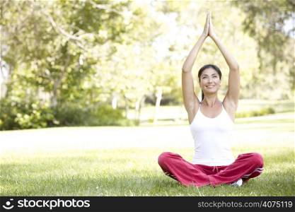 Young Woman Doing Yoga In Park