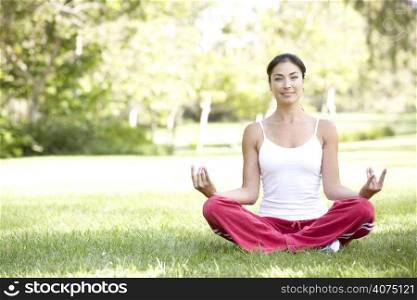 Young Woman Doing Yoga In Park