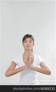 young woman doing yoga indoors. Copy space
