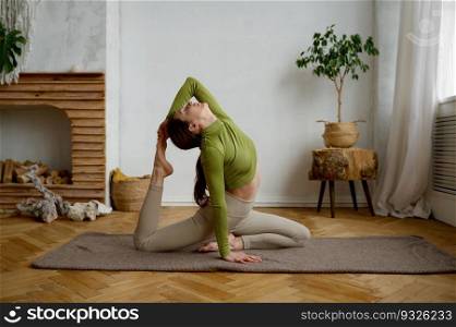 Young woman doing yoga stretching exercise pulling leg to head. Wellbeing and healthy sport lifestyle concept. Young woman doing yoga stretching exercise pulling leg to head