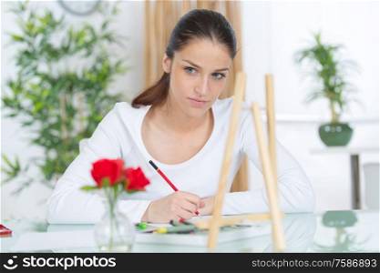 young woman drawing in coloring book