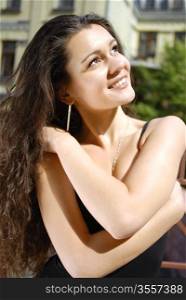young woman dreams about happy life and enjoying the sun