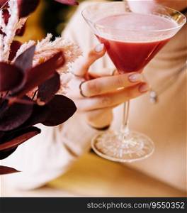 young woman drink red cocktail with strawberry