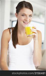 Young Woman Drinking A Glass Of Orange Juice