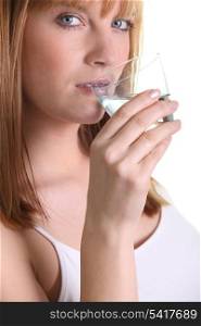 Young woman drinking a glass of water