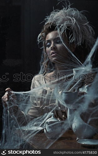 Young woman drinking coffee in old interior