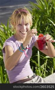 Young woman drinking frozen drink