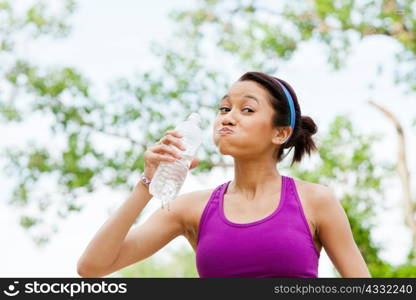 Young woman drinking mineral water