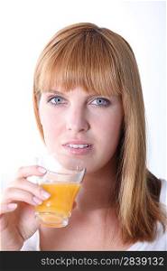 Young woman drinking orange juice isolated on white background