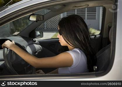 Young woman driving car