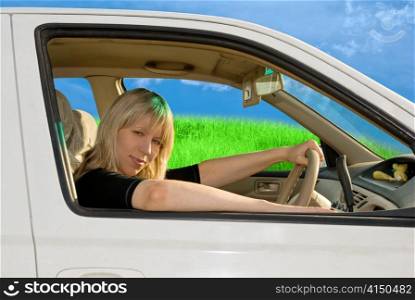 young woman driving car on nature background