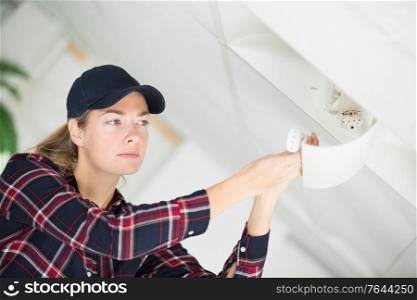 young woman during installation of kitchen furniture