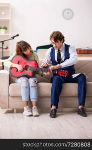 Young woman during music lesson with male teacher