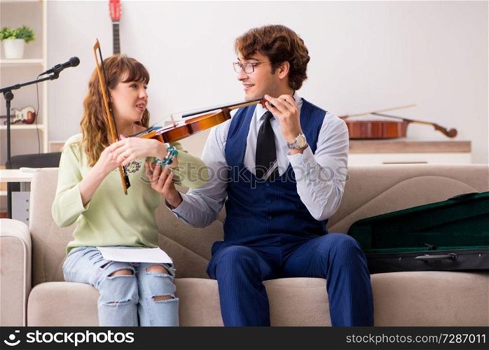 Young woman during music lesson with male teacher