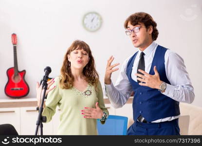 Young woman during music lesson with male teacher