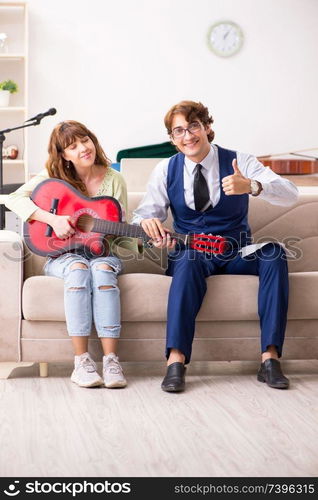 Young woman during music lesson with male teacher