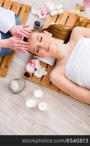 Young woman during spa procedure in salon