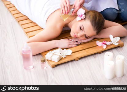 Young woman during spa procedure in salon