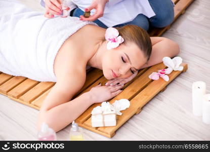 Young woman during spa procedure in salon