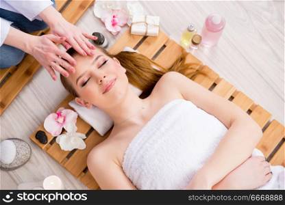 Young woman during spa procedure in salon