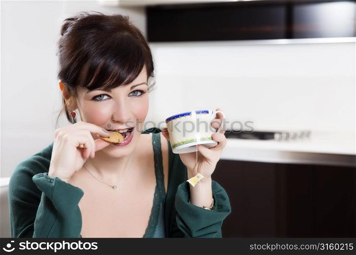 Young woman eating a biscuit