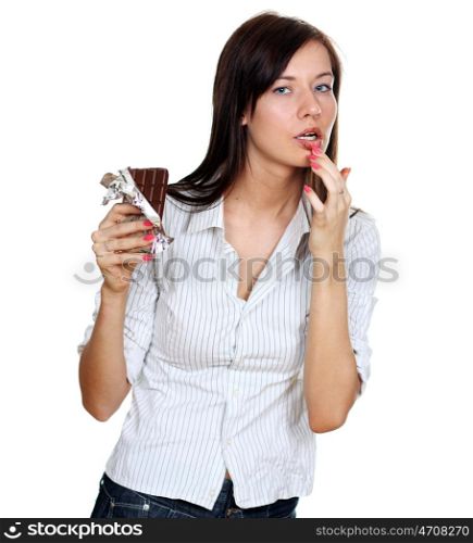 Young woman eating a chocolate candy, isolated on white