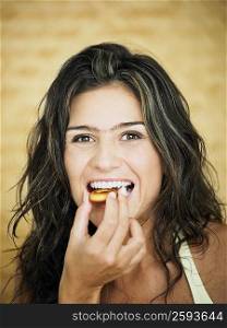 Young woman eating a cookie