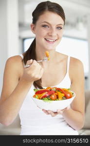 Young Woman Eating A Healthy Salad