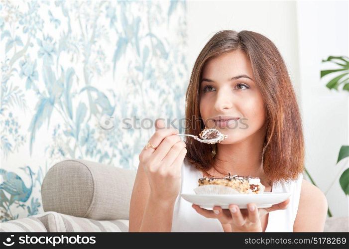 Young woman eating a piece of cake
