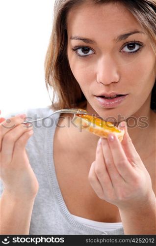 young woman eating a toast
