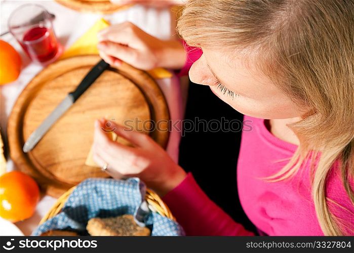 Young woman eating a traditional dinner with cheese