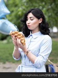 young woman eating bubble waffle