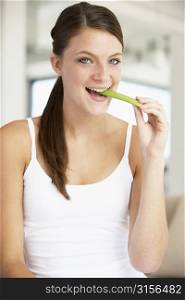 Young Woman Eating Celery Sticks